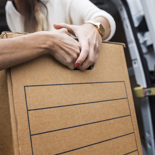 Man and woman carrying moving box